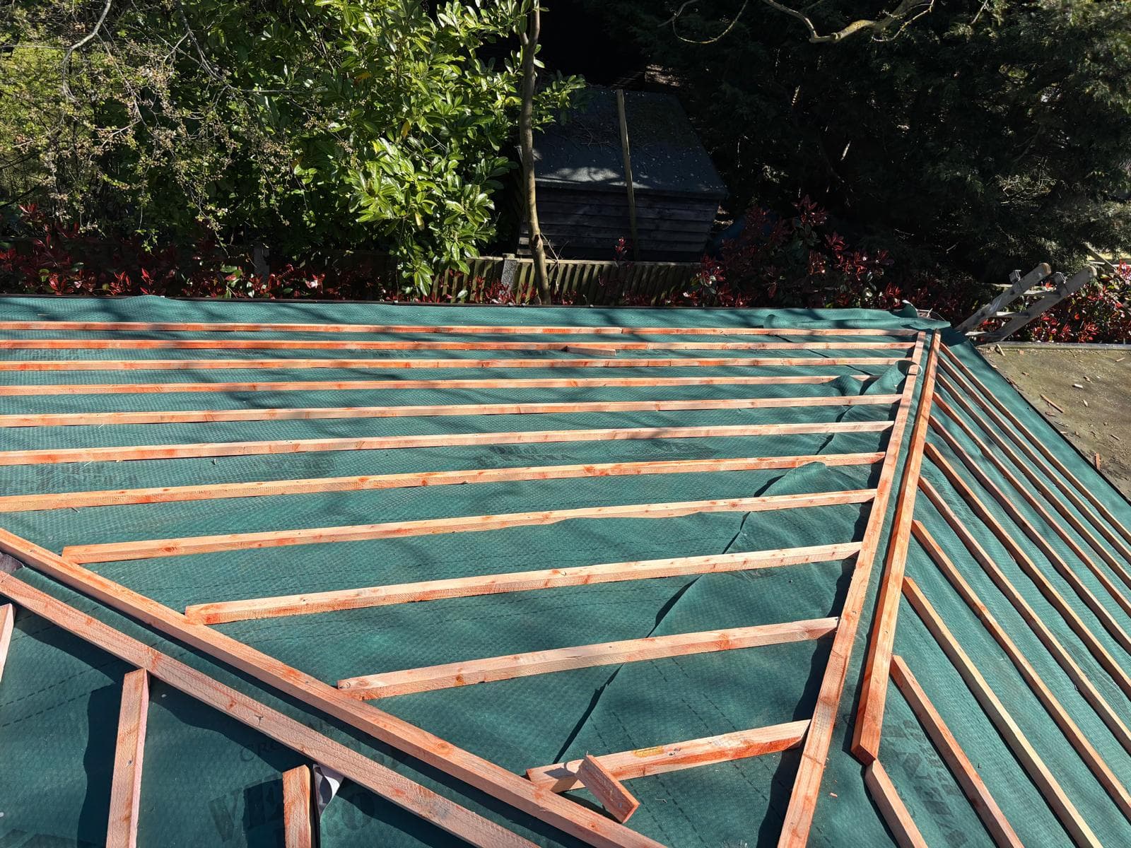 New battens fixed over green breathable membrane on a hipped roof