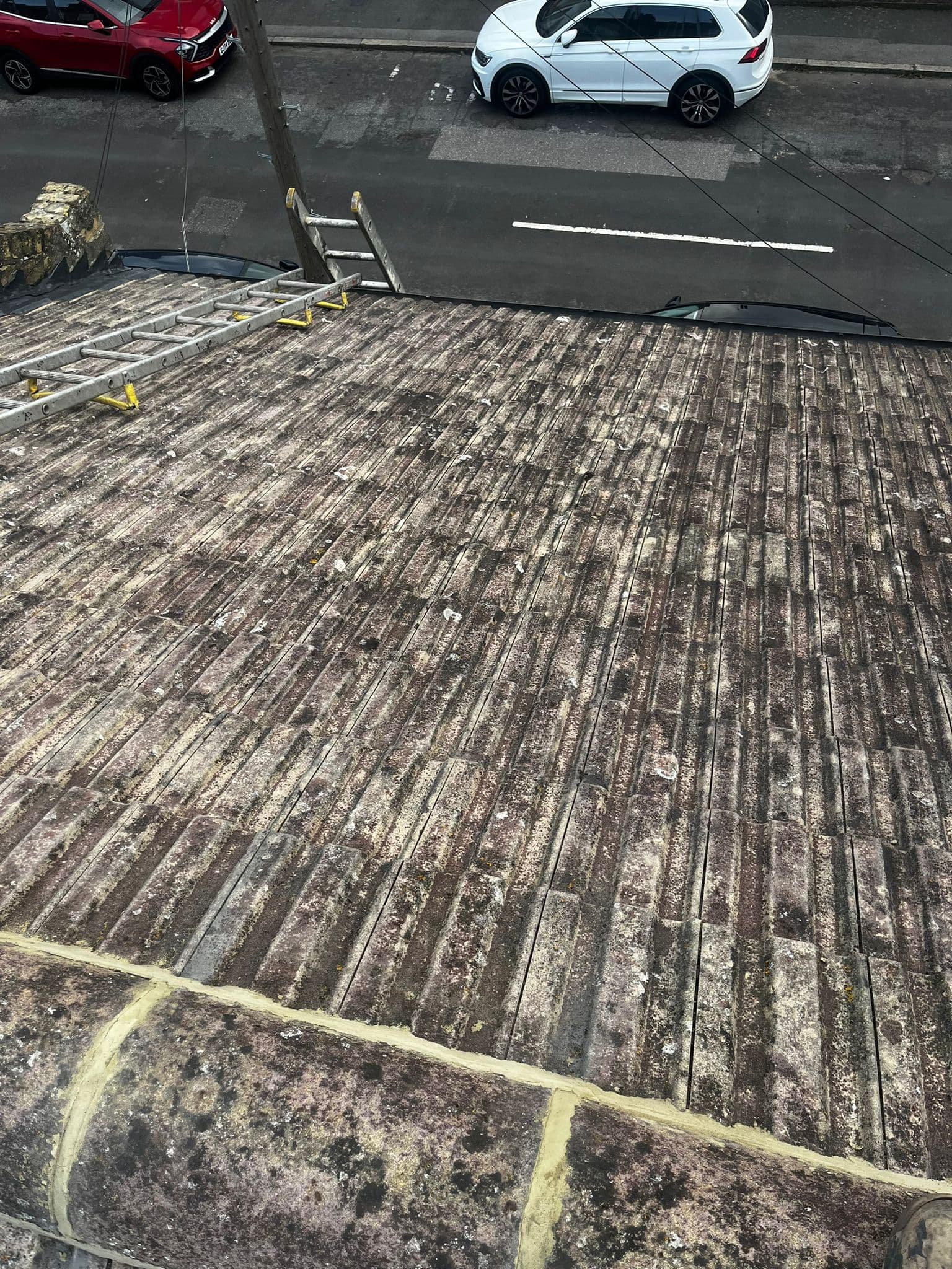 An old concrete tiled slope above a residential street