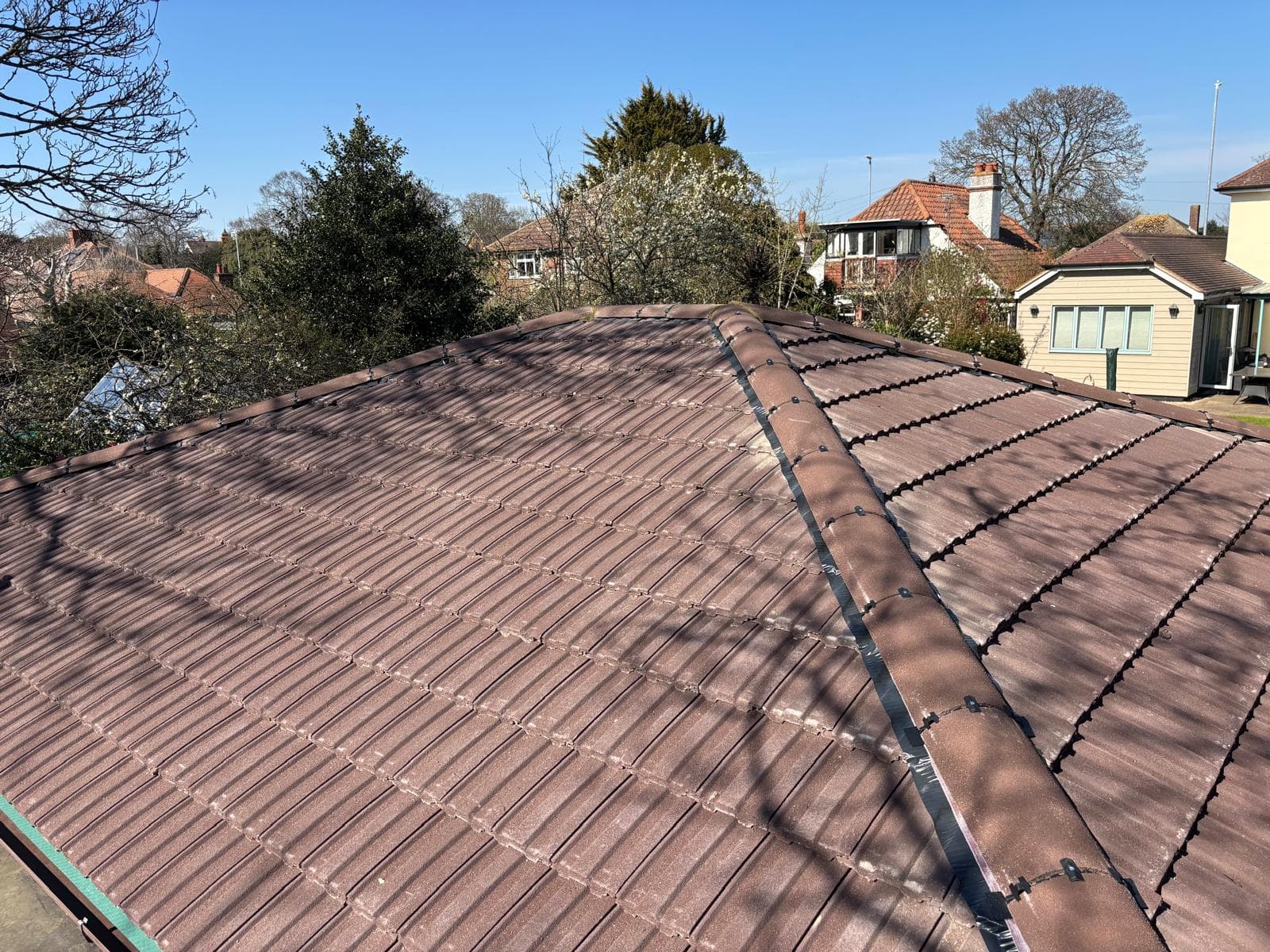 A low pitched tiled roof under open sky in Kent