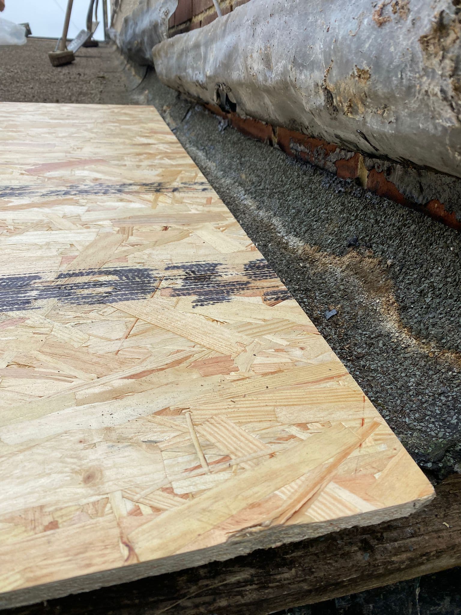 New timber decking boards laid on a flat roof, ready for the covering